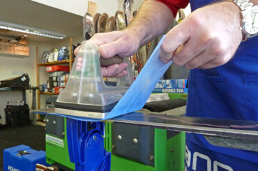 An iron gliding over skis which is ironing in wax